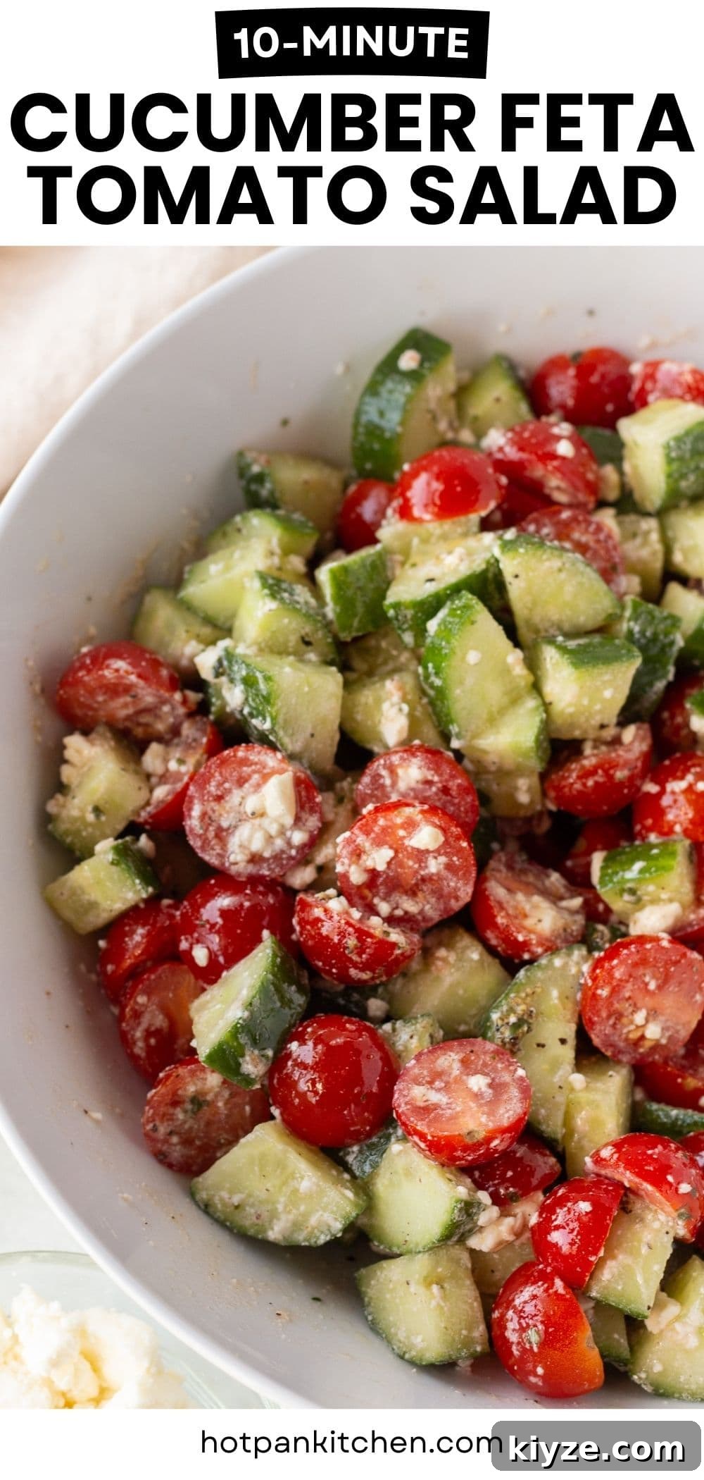 Quick Cucumber Tomato Salad with Feta in 10 Minutes 10 Close-up of a bowl filled with a salad made of chopped cucumbers, halved cherry tomatoes, and crumbled feta cheese, with seasoning visible, and the text “10-Minute Cucumber Feta Tomato Salad” at the top.