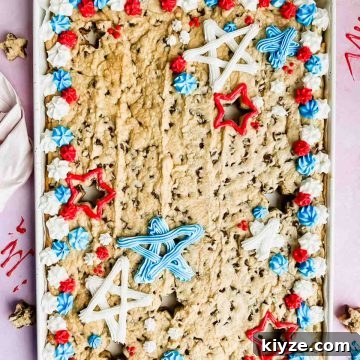Fourth of July Flag Cookie Cake Recipe 12 fourth of july cookie cake decorated with red, white and blue frosting in white baking tray.