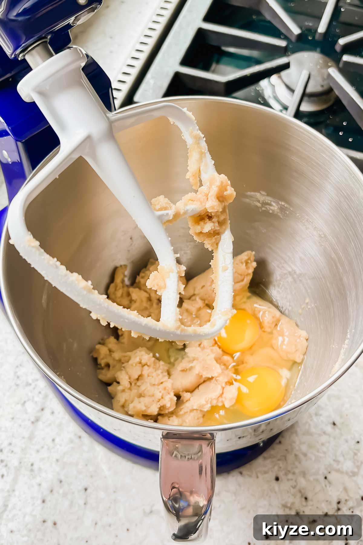 Fourth of July Flag Cookie Cake Recipe 5 eggs and dough in mixer bowl.