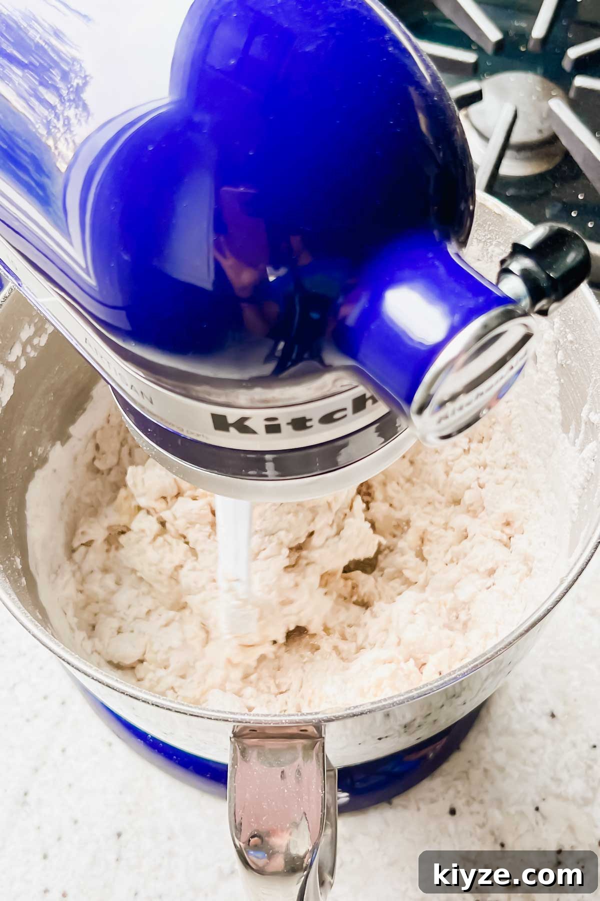 Fourth of July Flag Cookie Cake Recipe 6 mixing dry ingredients into dough in mixer.