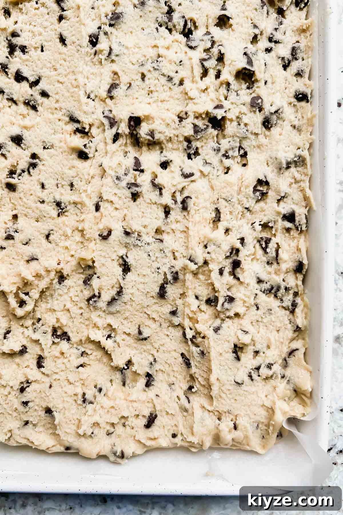 Fourth of July Flag Cookie Cake Recipe 8 cookie cake batter spread in sheet pan.