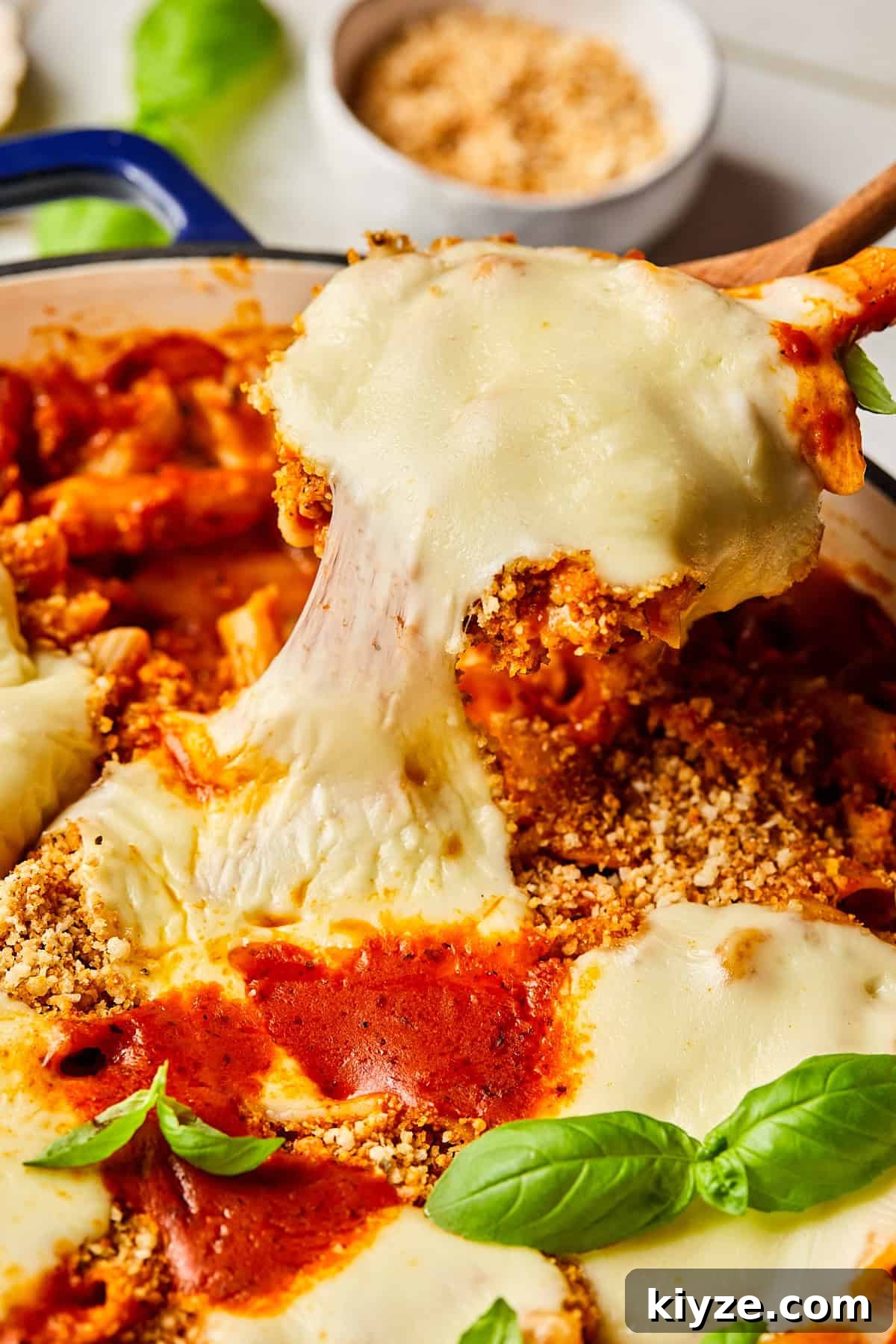 One-Pot Gluten-Free Chicken Parmesan Pasta Recipe 13 a spoon pulling a cheesy bite out of chicken parmesan pasta