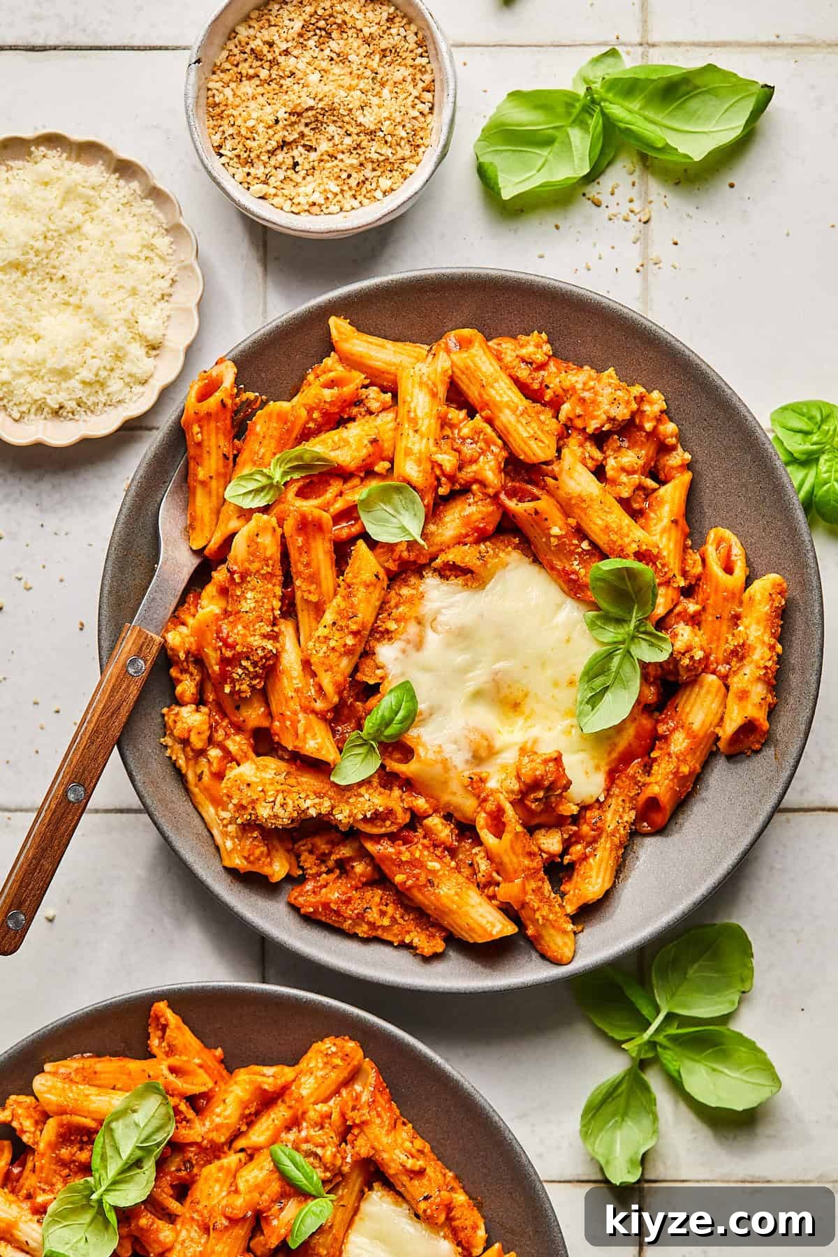 One-Pot Gluten-Free Chicken Parmesan Pasta Recipe 14 2 plates of pasta topped with mozzarella and basil