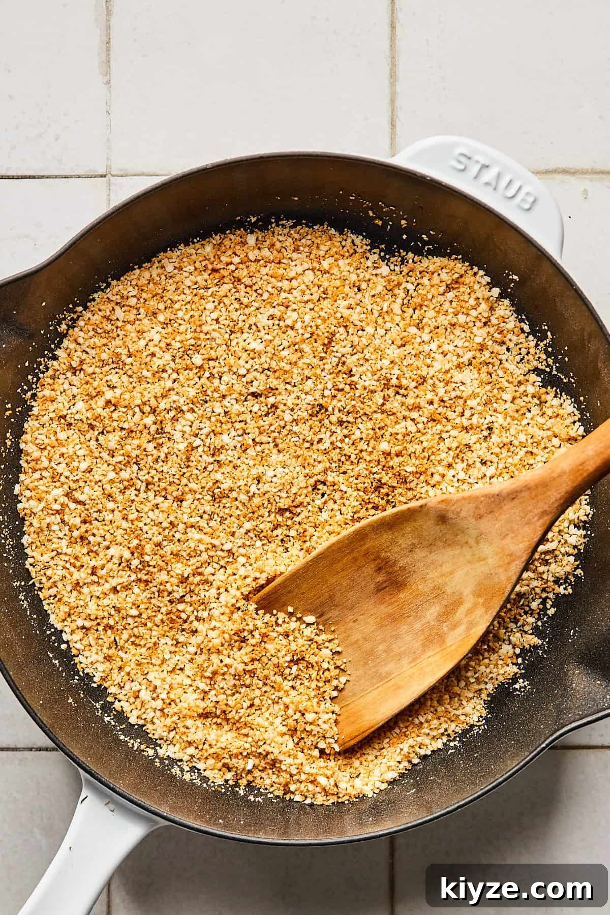 One-Pot Gluten-Free Chicken Parmesan Pasta Recipe 9 breadcrumbs in a cast iron pan with a wooden spoon