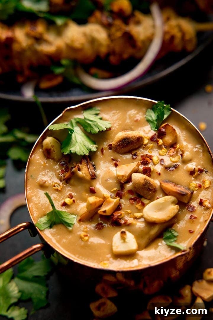 Homemade Satay Sauce Recipe for Grilled Chicken and Shrimp 2 Peanut satay sauce in a small copper pan topped with peanuts and coriander
