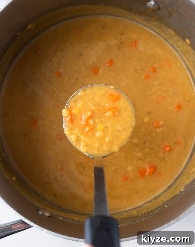Traditional Lebanese Red Lentil Soup Recipe 7 Top view of a pot of cooked Lebanese lentil soup.