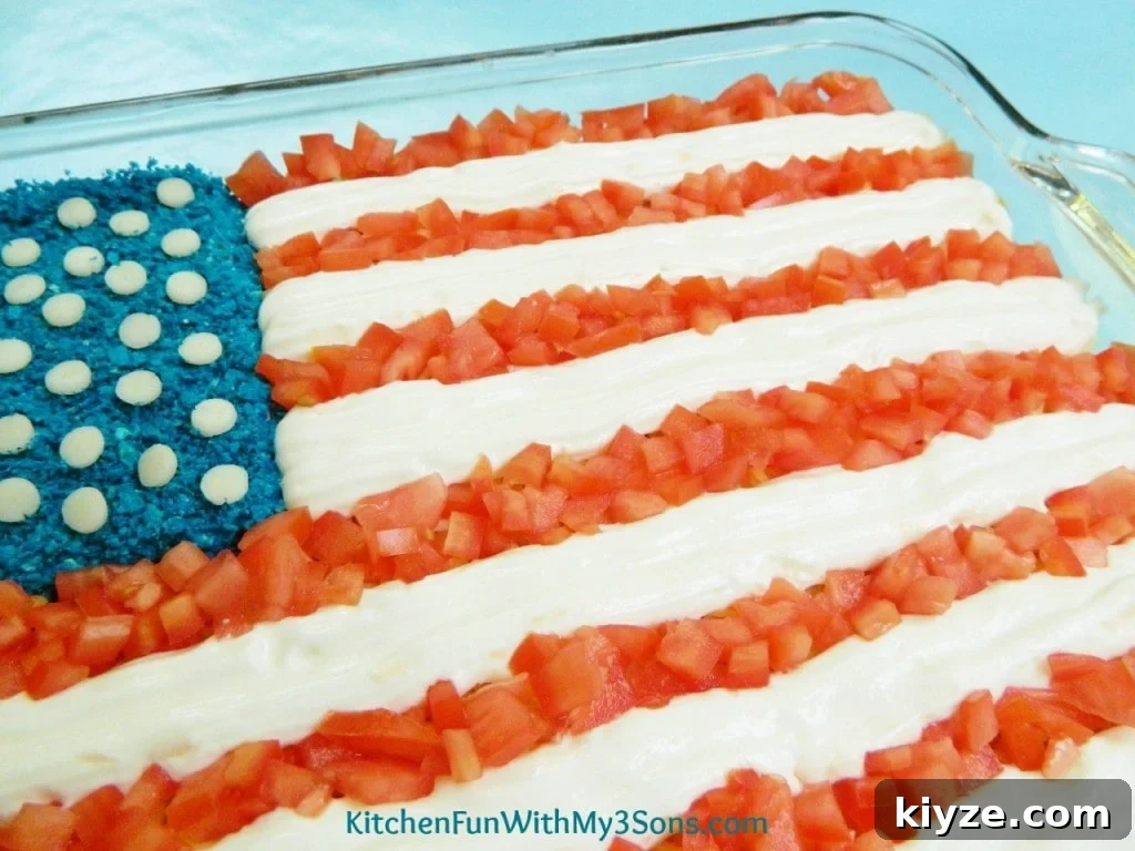 Patriotic 7-Layer Flag Dip Recipe for 4th of July Parties 4 7 layer flag dip sour cream and tomatoe stripes