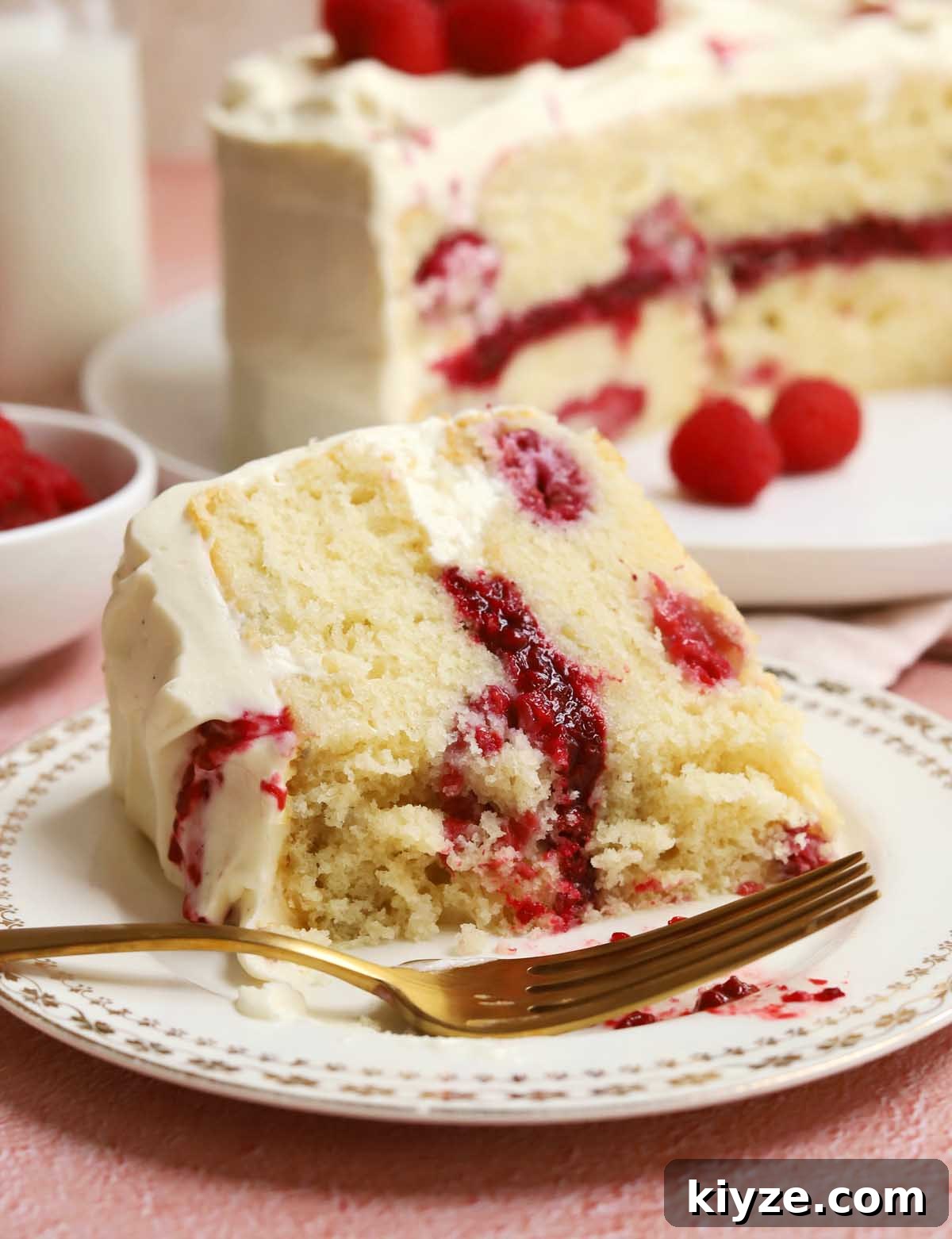 Decadent White Chocolate Raspberry Layer Cake Recipe 4 white chocolate raspberry cake slice with bite