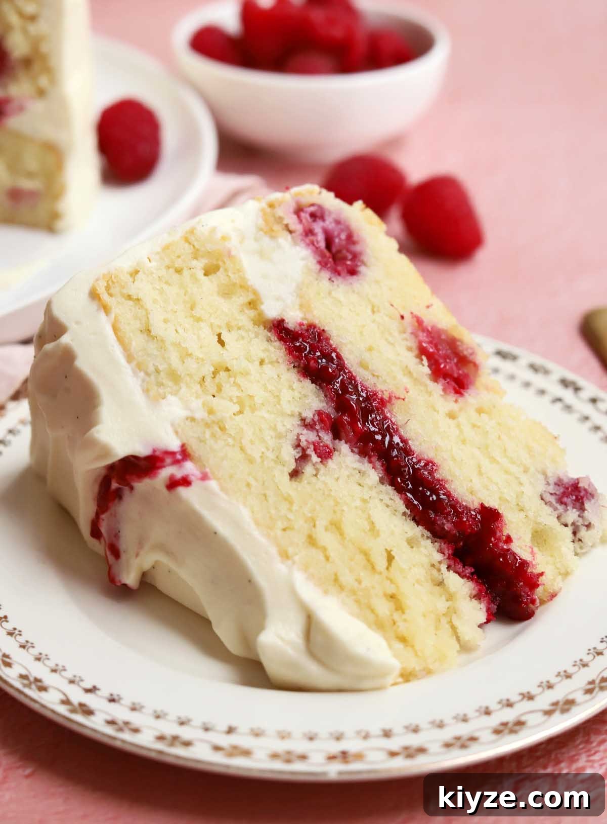 Decadent White Chocolate Raspberry Layer Cake Recipe 7 white chocolate raspberry cake slice on a plate