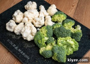Cheesy Cauliflower and Broccoli Casserole Recipe 6 Cauliflower and broccoli florets on a marble chopping board