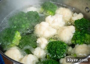 Cheesy Cauliflower and Broccoli Casserole Recipe 7 Cauliflower and Broccoli florets in boiling water in a cooking pot