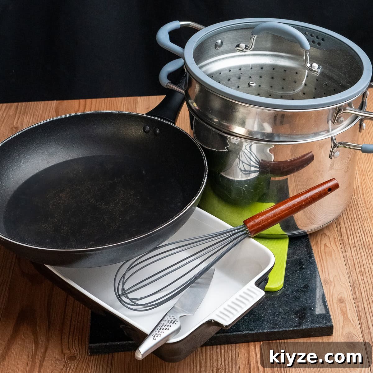 Cheesy Cauliflower and Broccoli Casserole Recipe 28 A large cooking pot with sieve and lid,whisk,sharp knife,oven proof dish , a frying pan and a marble chopping board