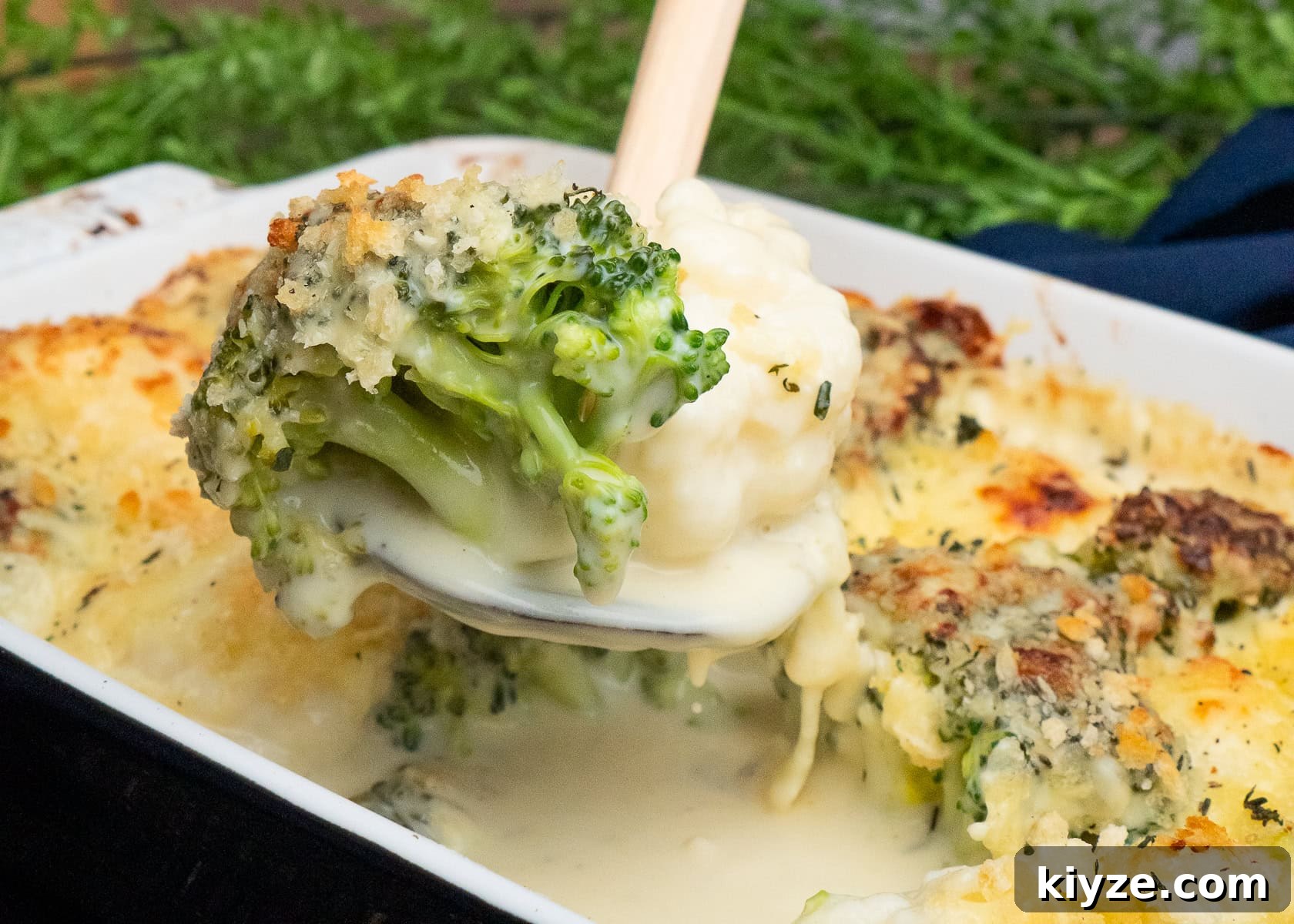 Cheesy Cauliflower and Broccoli Casserole Recipe 30 Cauliflower and Broccoli Cheese being picked up with a spoon with melted cheese sauce dripping down