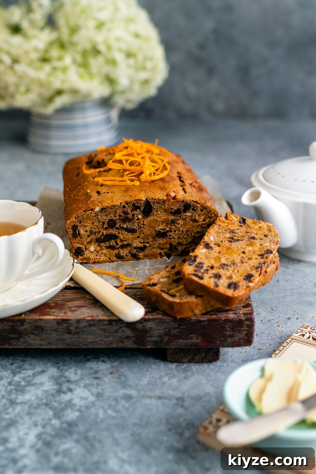 Tea-Infused Fruit Loaf Recipe for Afternoon Tea 3 Sliced Tea loaf topped with orange zest