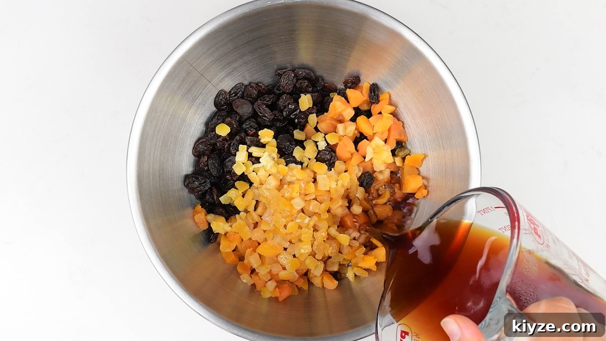 Tea-Infused Fruit Loaf Recipe for Afternoon Tea 5 adding tea to a bowl of mixed dried fruit