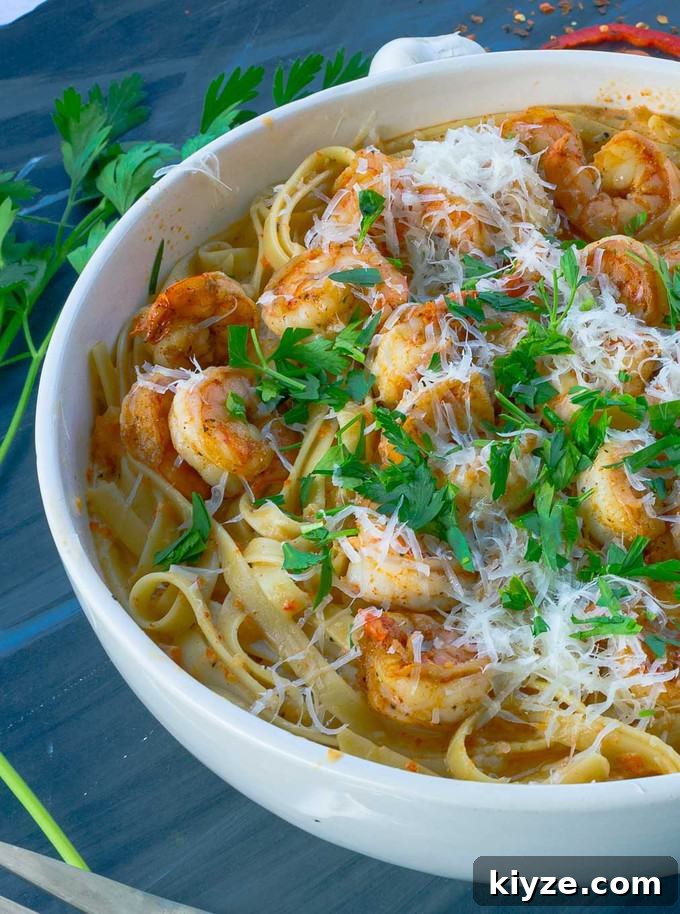 Cajun Shrimp Pasta with Roasted Red Pepper Sauce 2 white bowl of roastedred pepper pasta on gray background with parsley