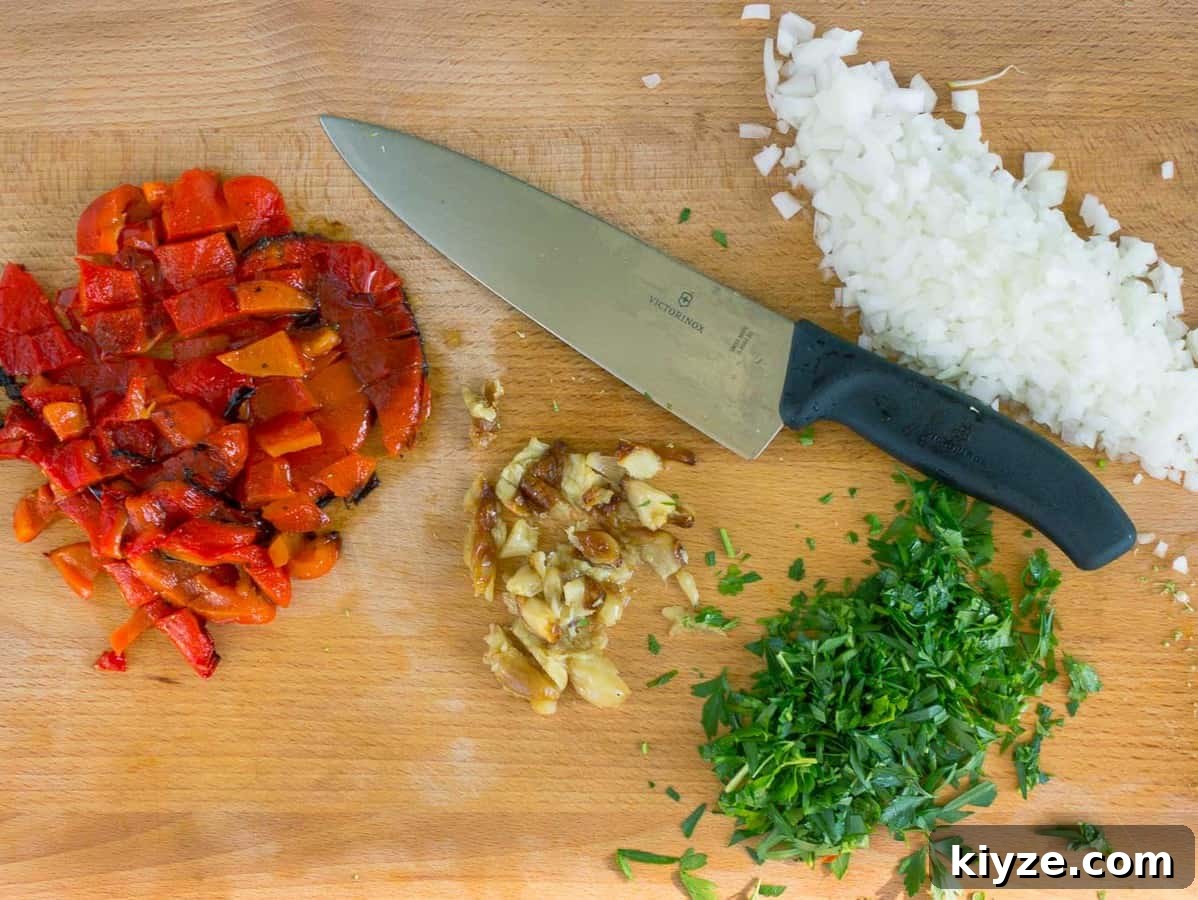 Cajun Shrimp Pasta with Roasted Red Pepper Sauce 4 wooden cutting board, knife, chopped onion, roasted garlic and red pepper, and parsley