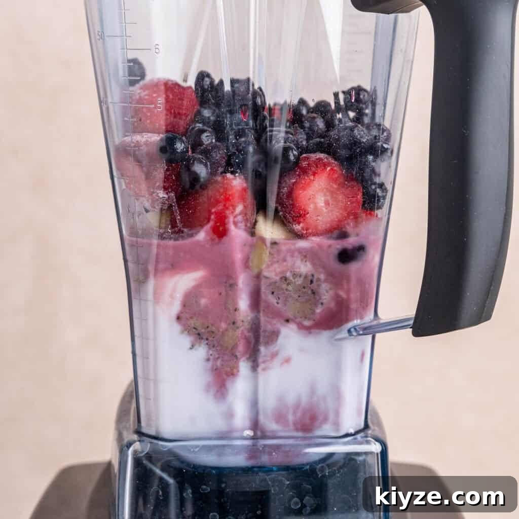 Creamy Banana and Berry Protein Smoothie Recipe 4 Kefir, pomegranate juice, hemp seeds, protein powder, and fruit in a Vitamix blender.