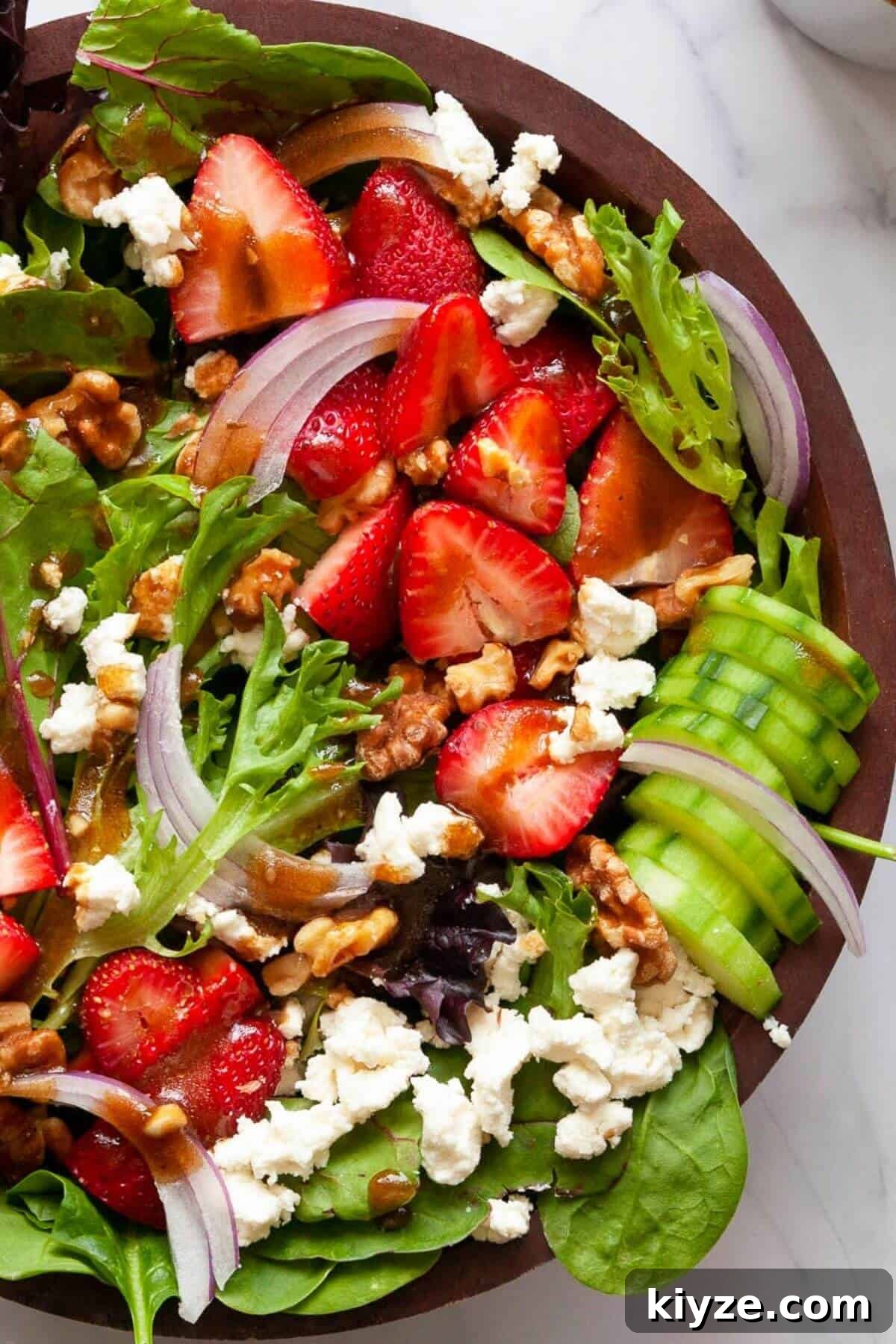 Fresh and simple strawberry goat cheese salad with balsamic dressing and walnuts.