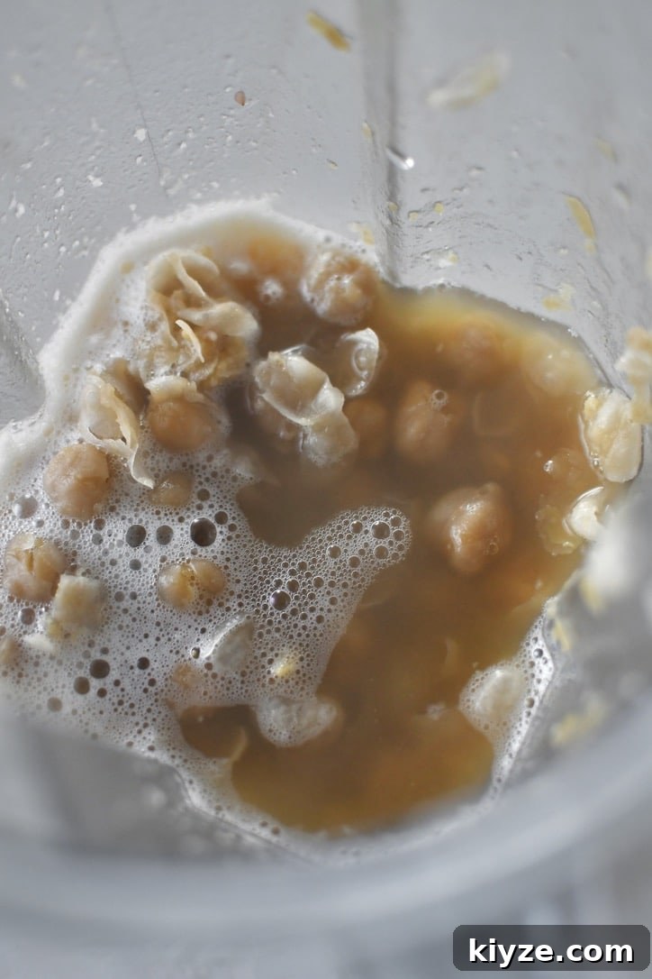 Creamy Homemade Hummus: Simple Recipe with Tahini & Lemon 6 Cooked chickpeas in a high speed blender with the cooking liquid ready to be pureed.
