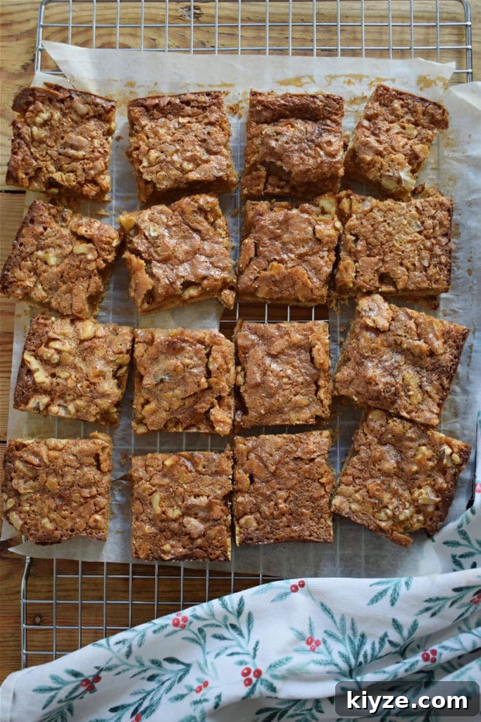 Chewy Maple Walnut Bars with Brown Butter Glaze 18 Maple walnut cookies cut into squares on a baking tray