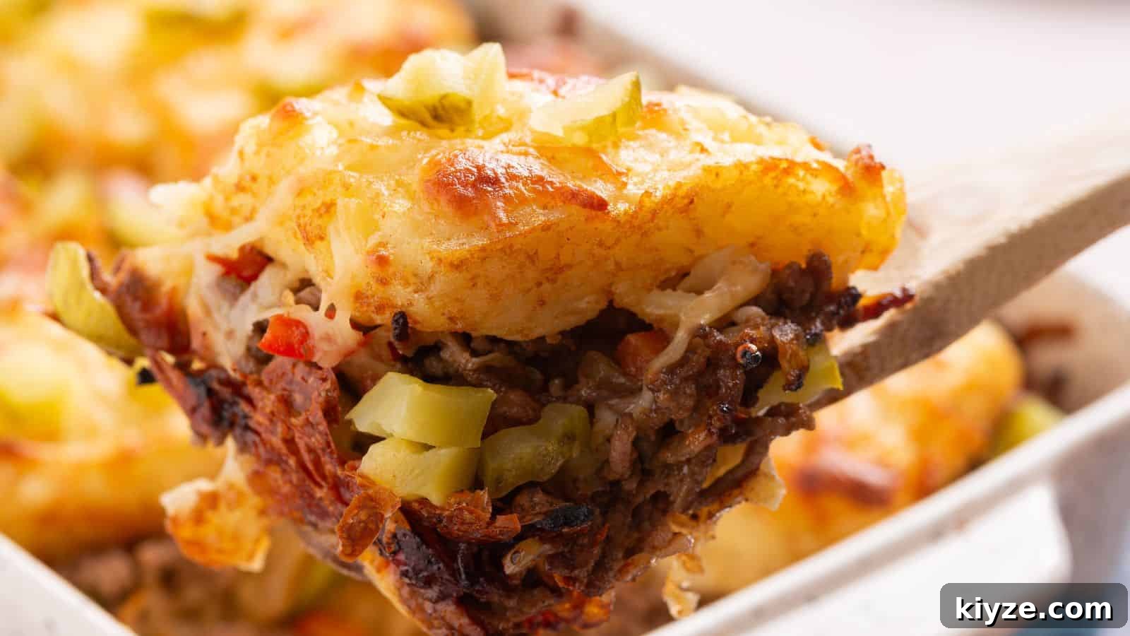 Cheesy hashbrown topped casserole in baking pan.