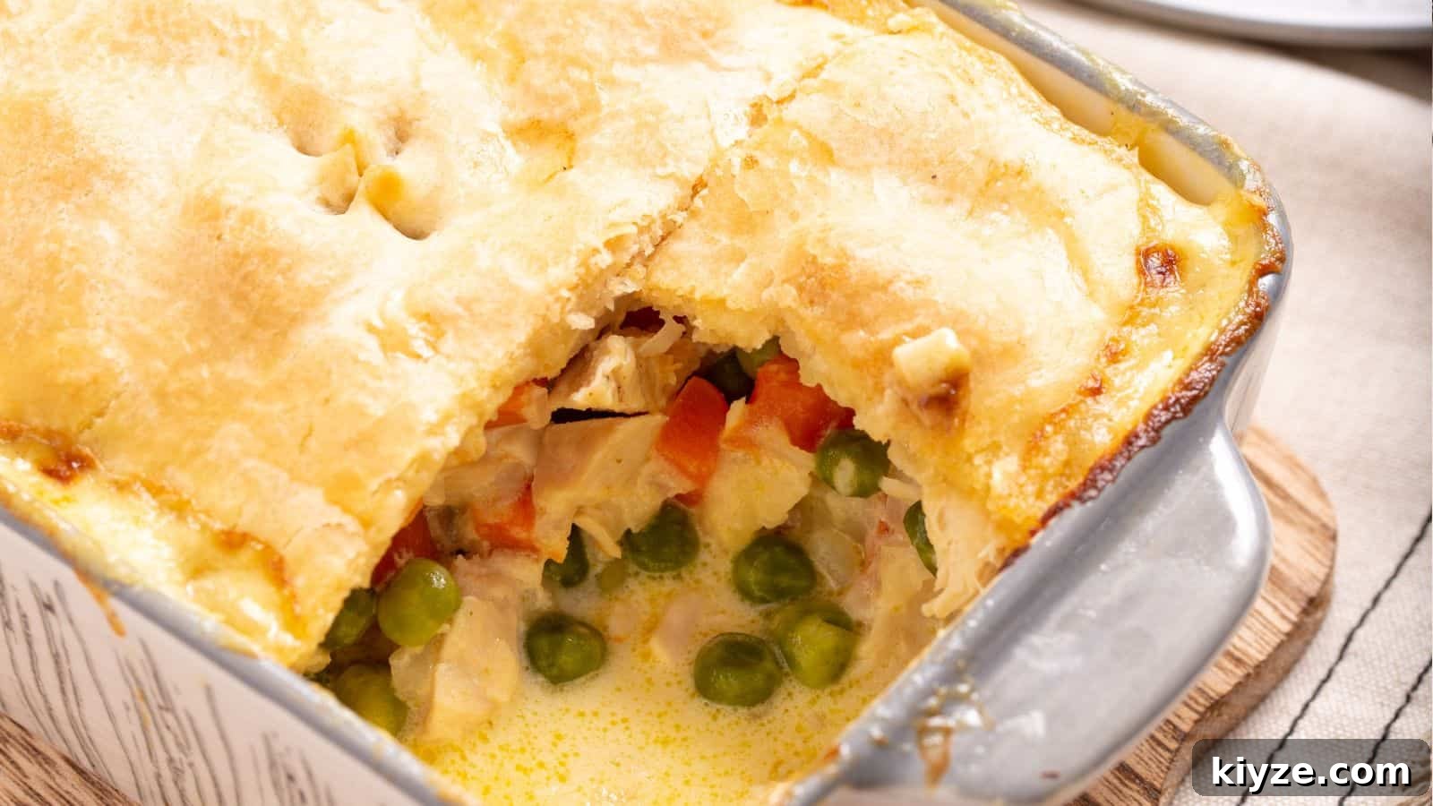 Small serving of chicken pot pie casserole on plate with fork.