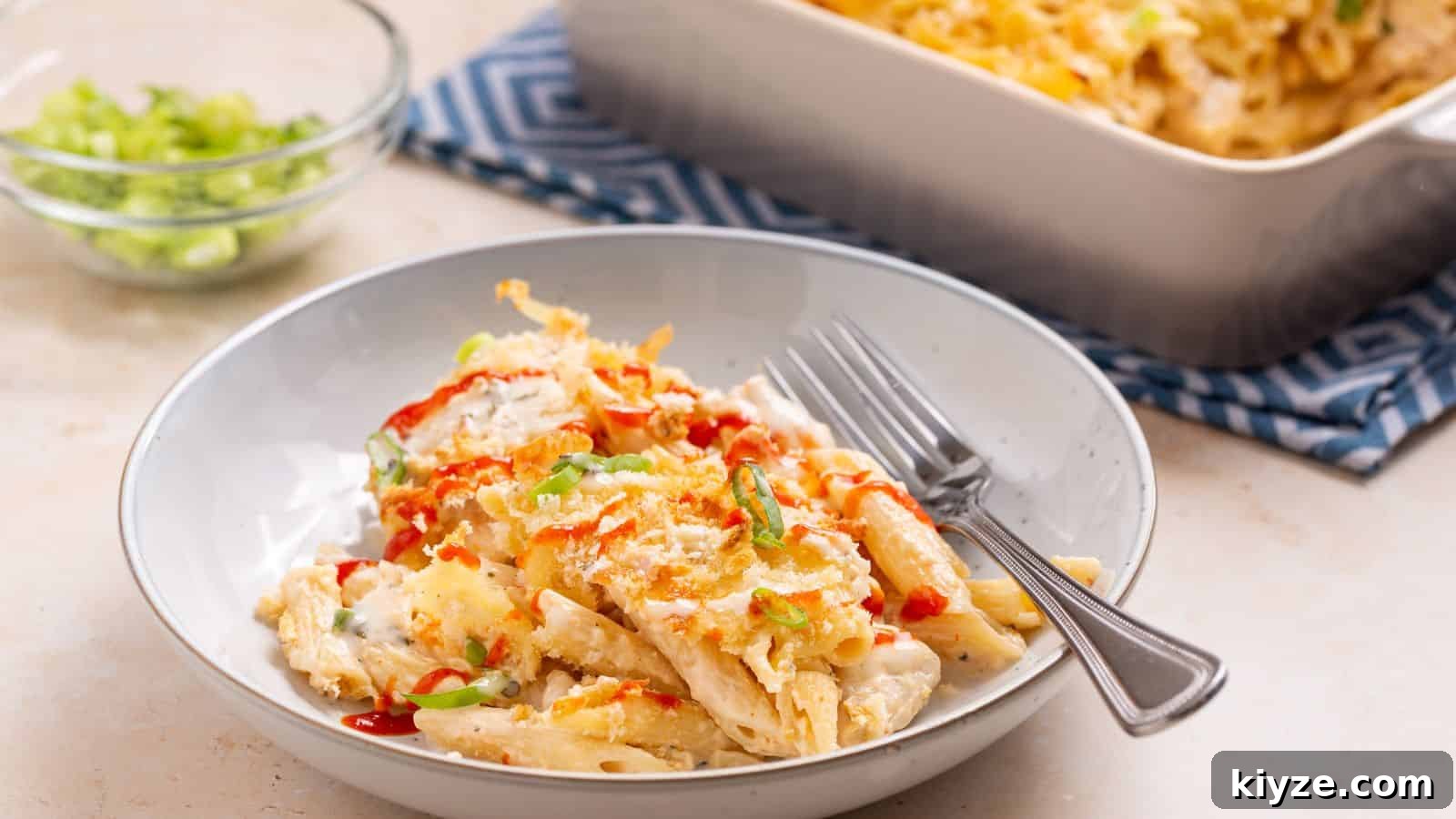 25 Comforting Main Dishes That Make You Forget the Grill 20 Serving of buffalo chicken pasta bake with casserole dish.