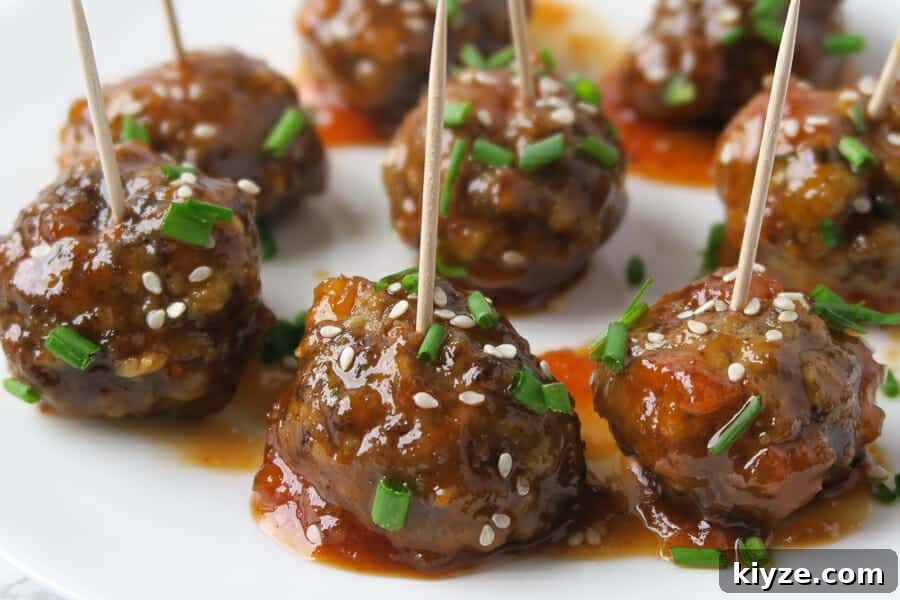Sweet and Spicy Apricot Glaze for Meatballs and Dipping Sauce 2 sweet & spicy meatball appetizer garnished with chives and sesame seeds