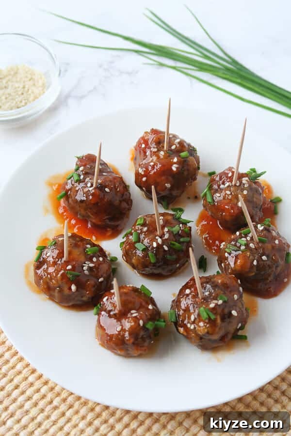 Sweet and Spicy Apricot Glaze for Meatballs and Dipping Sauce 5 sweet & spicy meatball appetizer garnished with chives and sesame seeds