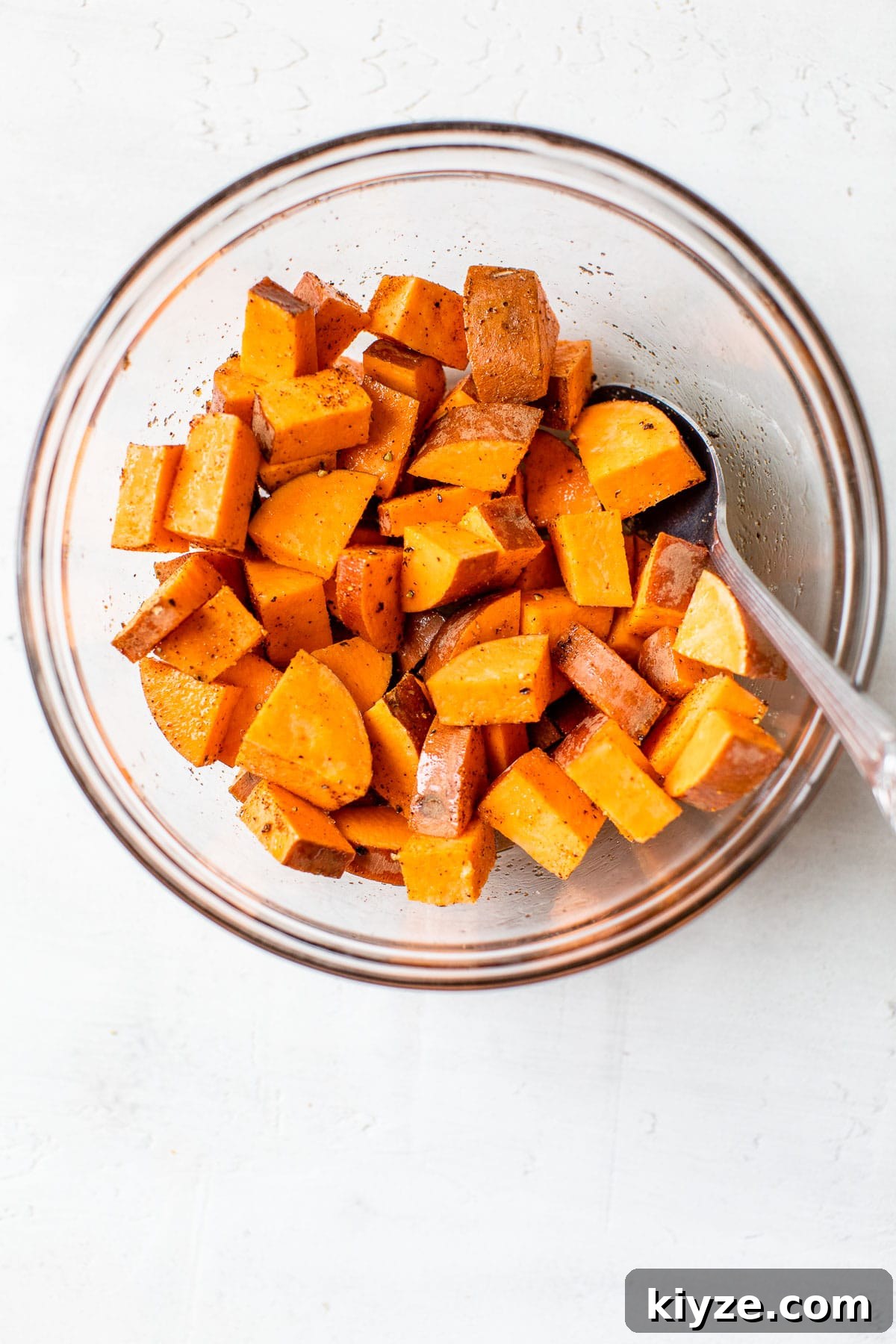 Crispy Air Fryer Sweet Potatoes: Quick Roasted Sweet Potato Recipe 4 diced sweet potatoes in a glass bowl
