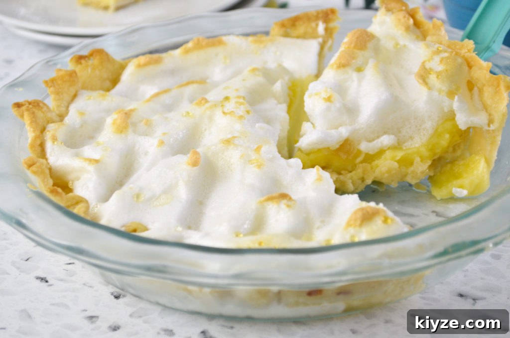 Classic Lemon Meringue Pie Recipe: Zesty Citrus Filling & Fluffy Meringue 2 lemon meringue whole w slice