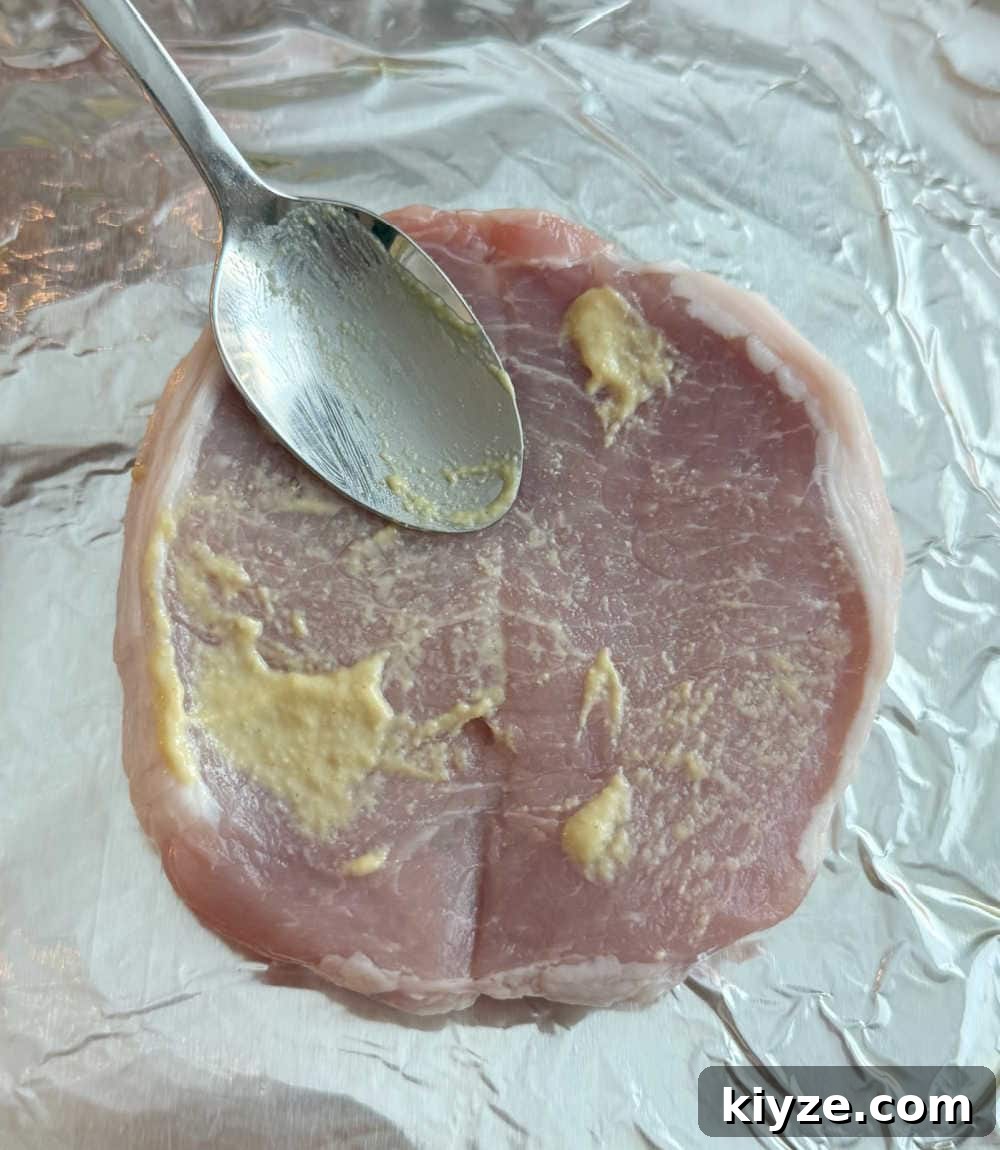 Brown Sugar Baked Pork Chops with Caramelized Glaze 5 spread mustard on chops.