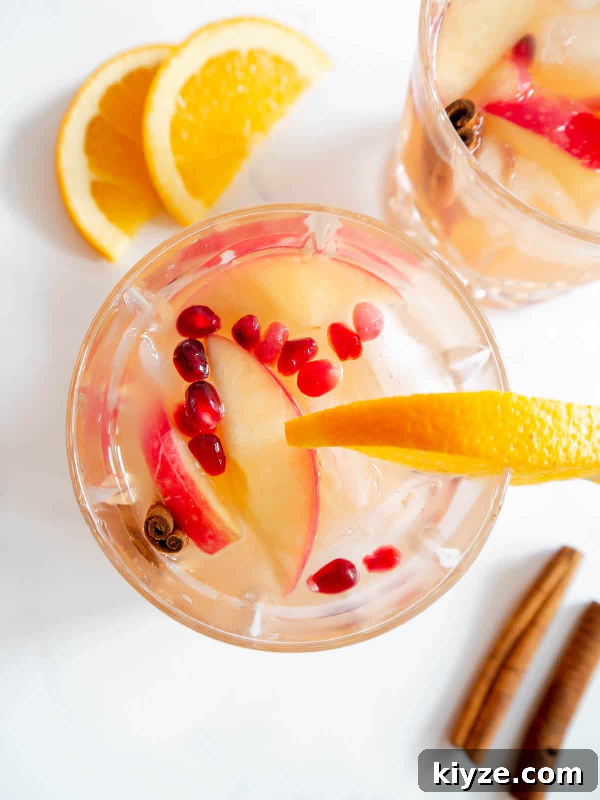 Apple Cider Whiskey Cocktail with pomegranate seeds added to the cups.
