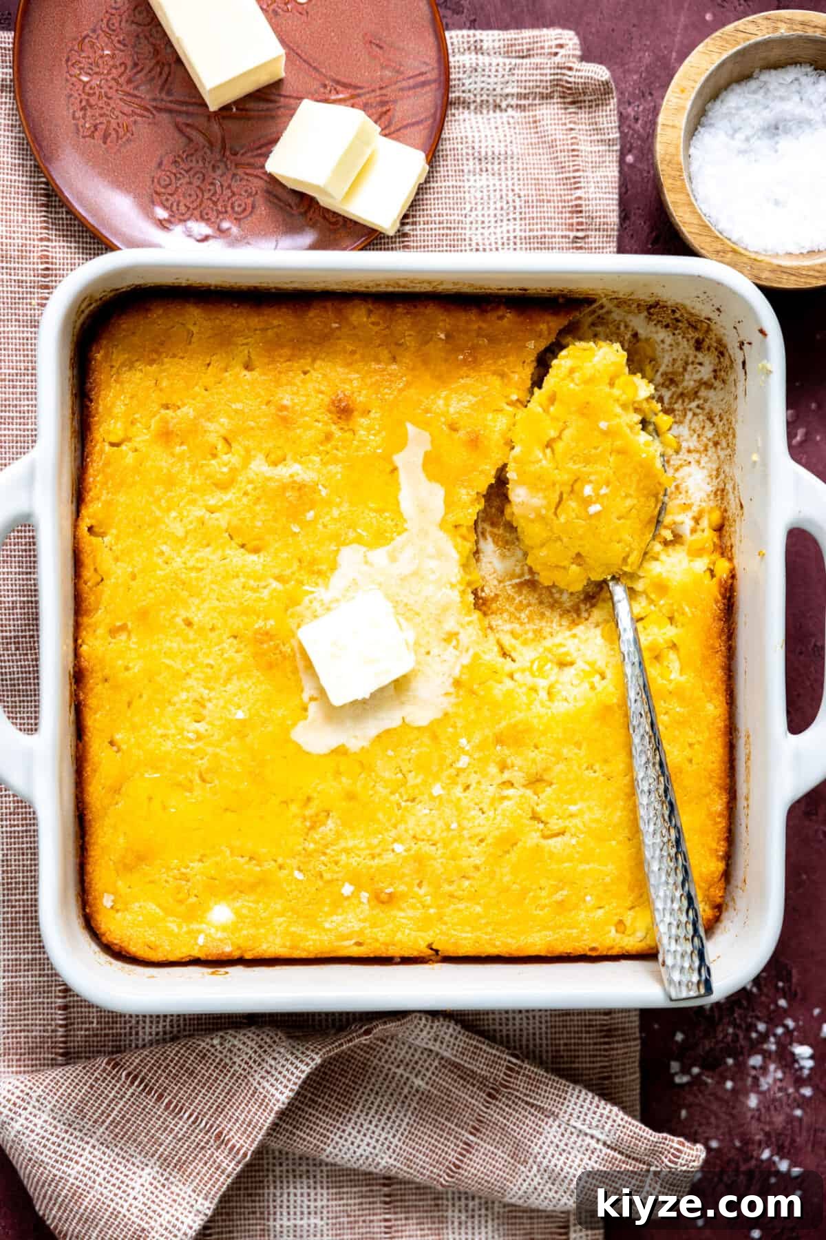 Cheesy Cornbread Casserole with Sausage and Sweet Corn 2 White baking dish with cornbread pudding.