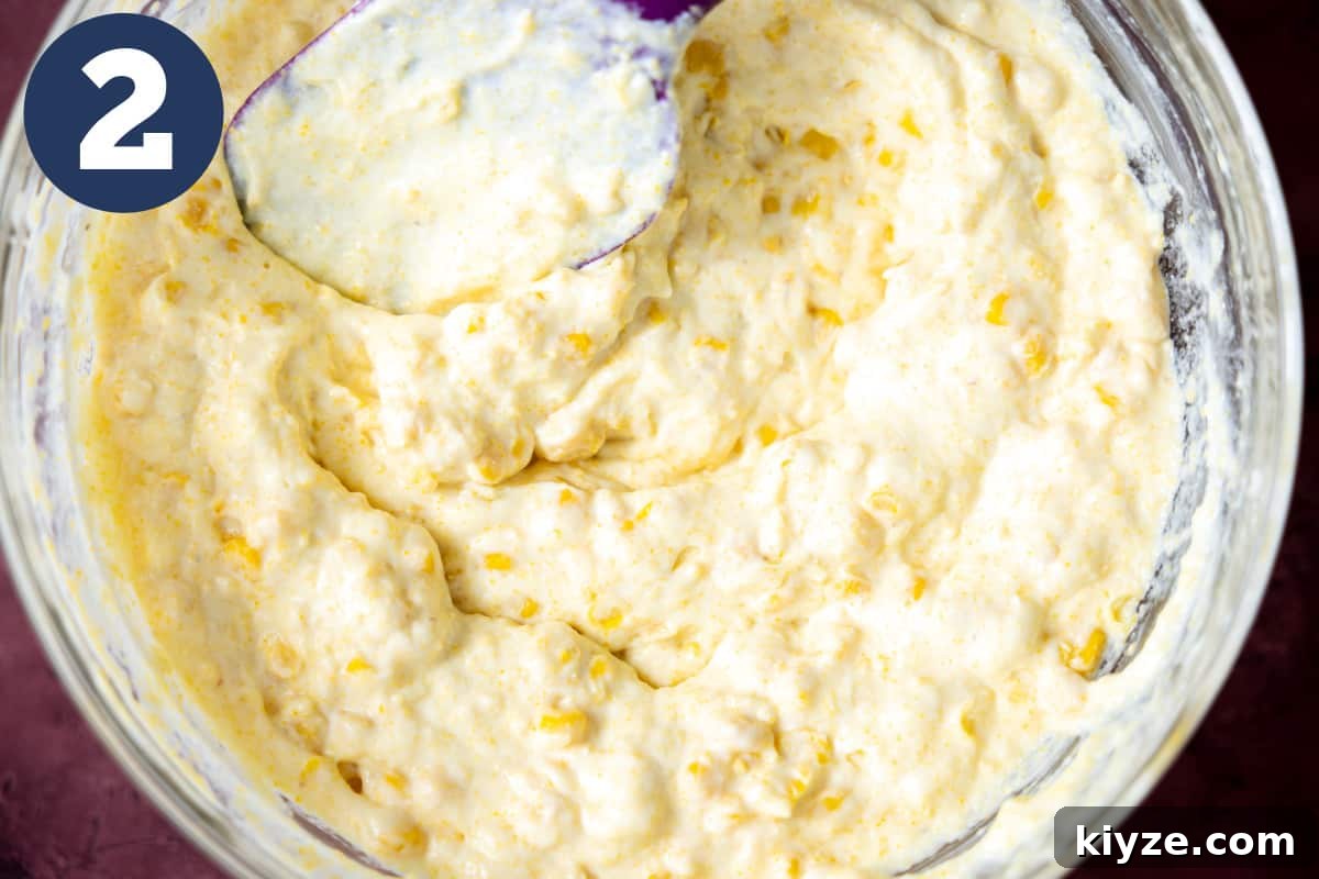 Cheesy Cornbread Casserole with Sausage and Sweet Corn 5 Bowl filled with mixed batter for corn casserole.