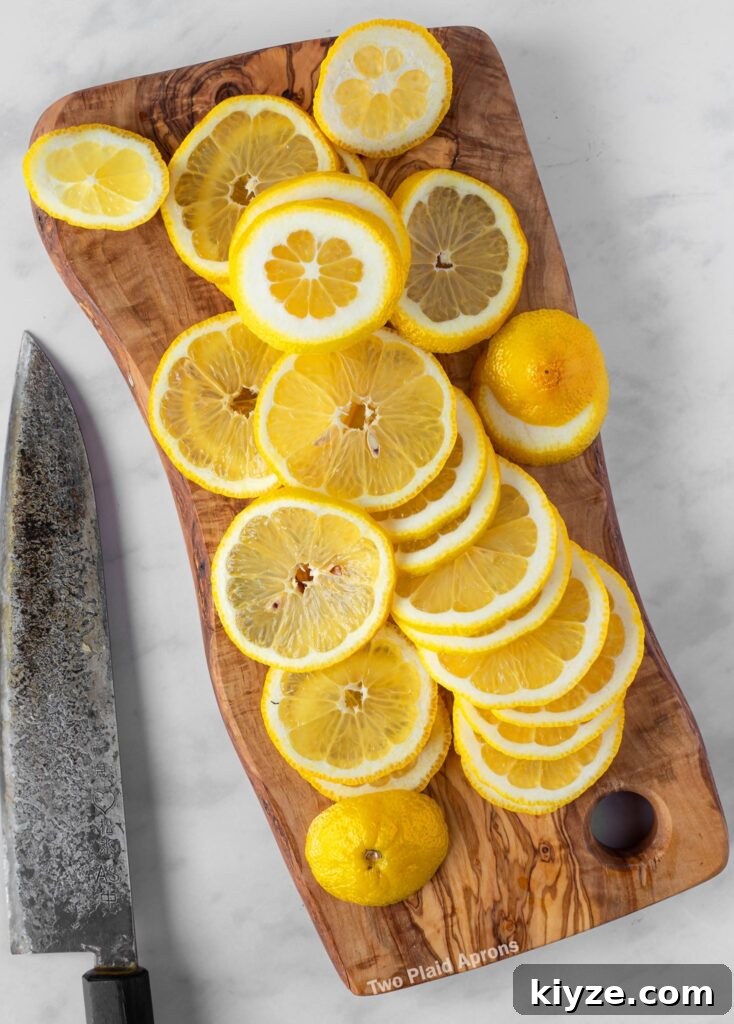 Pink Lemonade with Black Wolfberries: Refreshing Homemade Recipe 11 Thinly sliced lemons on a cutting board.