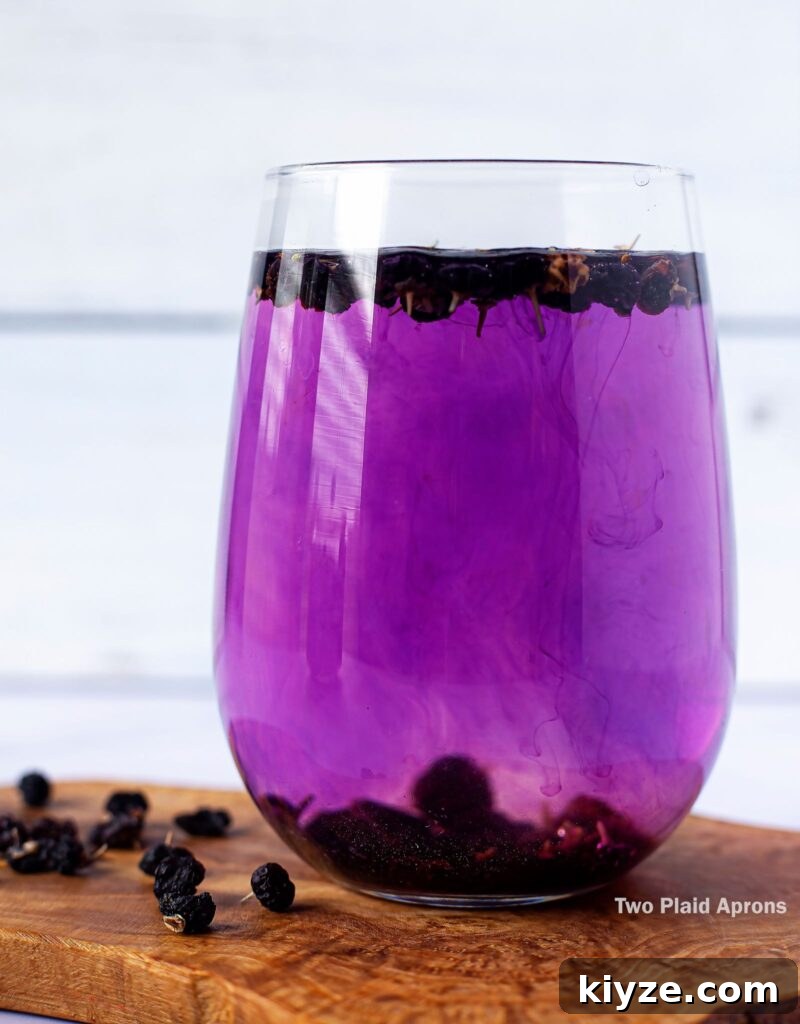 Pink Lemonade with Black Wolfberries: Refreshing Homemade Recipe 8 A glass of black wolfberry tea turning completely pinkish purple.