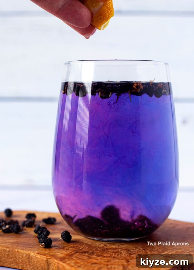 Pink Lemonade with Black Wolfberries: Refreshing Homemade Recipe 9 Adding a squeeze of lemon juice into the black wolf berry tea.
