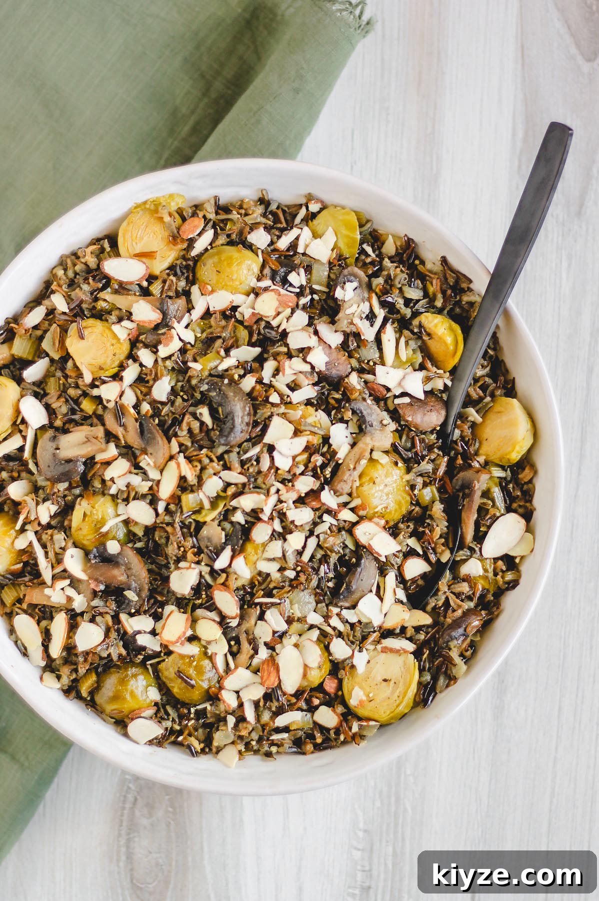 Slow Cooker Wild Rice Pilaf Recipe for Perfectly Fluffy Rice 2 wild rice pilaf in a large serving bowl sprinkled with sliced almonds