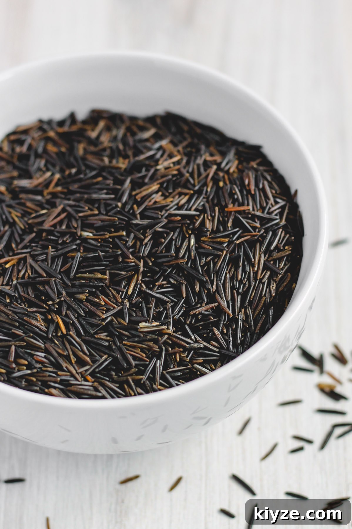 Slow Cooker Wild Rice Pilaf Recipe for Perfectly Fluffy Rice 3 uncooked wild rice in a white bowl