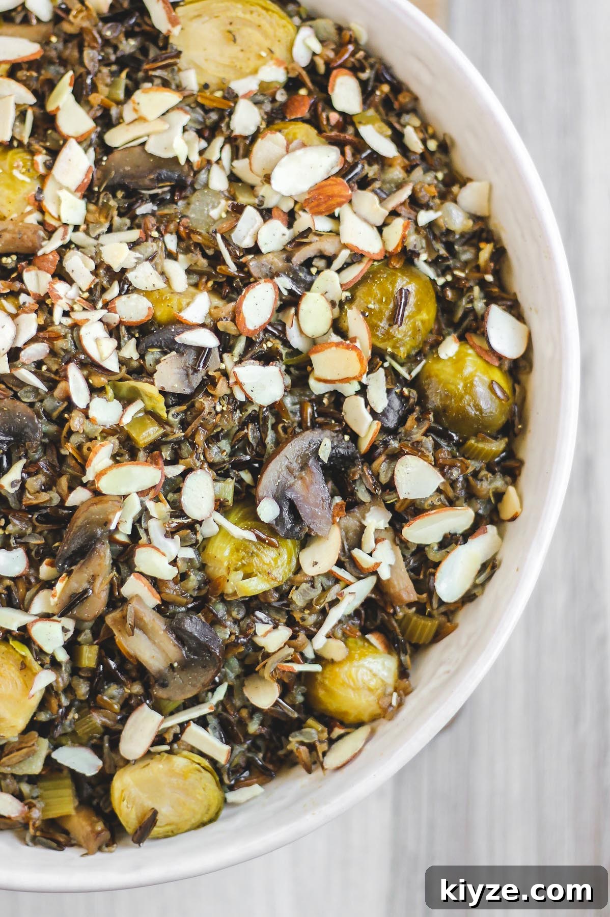 Slow Cooker Wild Rice Pilaf Recipe for Perfectly Fluffy Rice 7 close up view of cooked wild rice pilaf in large white serving bowl