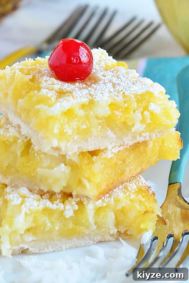 Pineapple Coconut Dessert Bars (Piña Colada) + Video 3 3 dessert bars stacked on a plate with forks