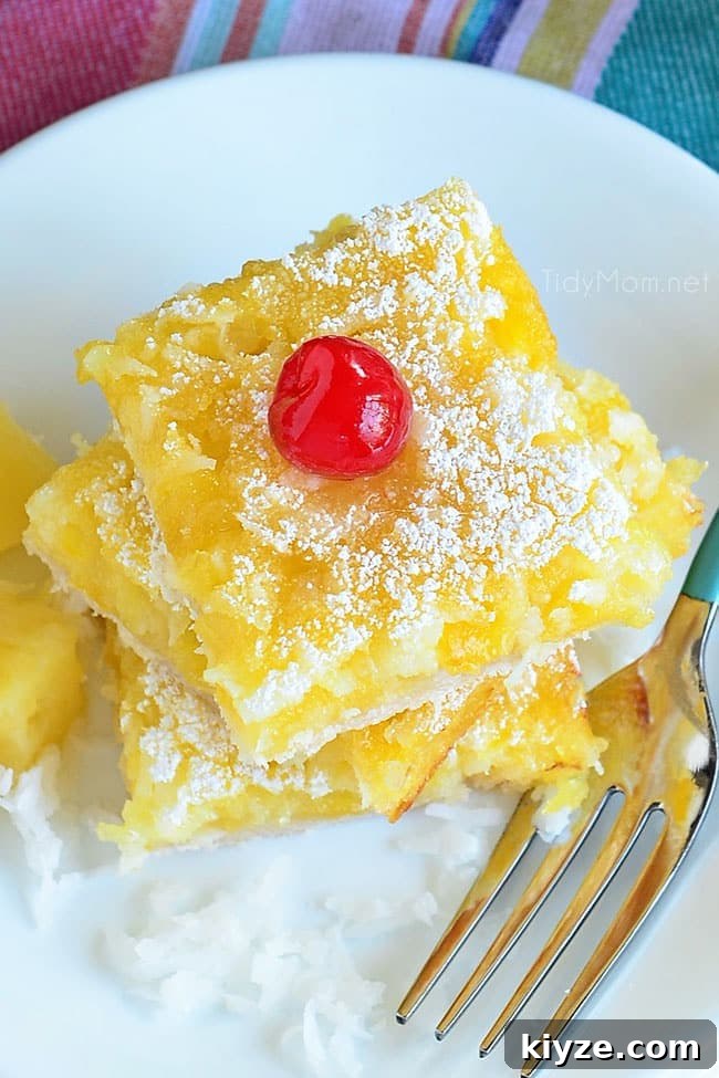 Pineapple Coconut Dessert Bars (Piña Colada) + Video 6 overhead shot of a stack of dessert bars on a white plate