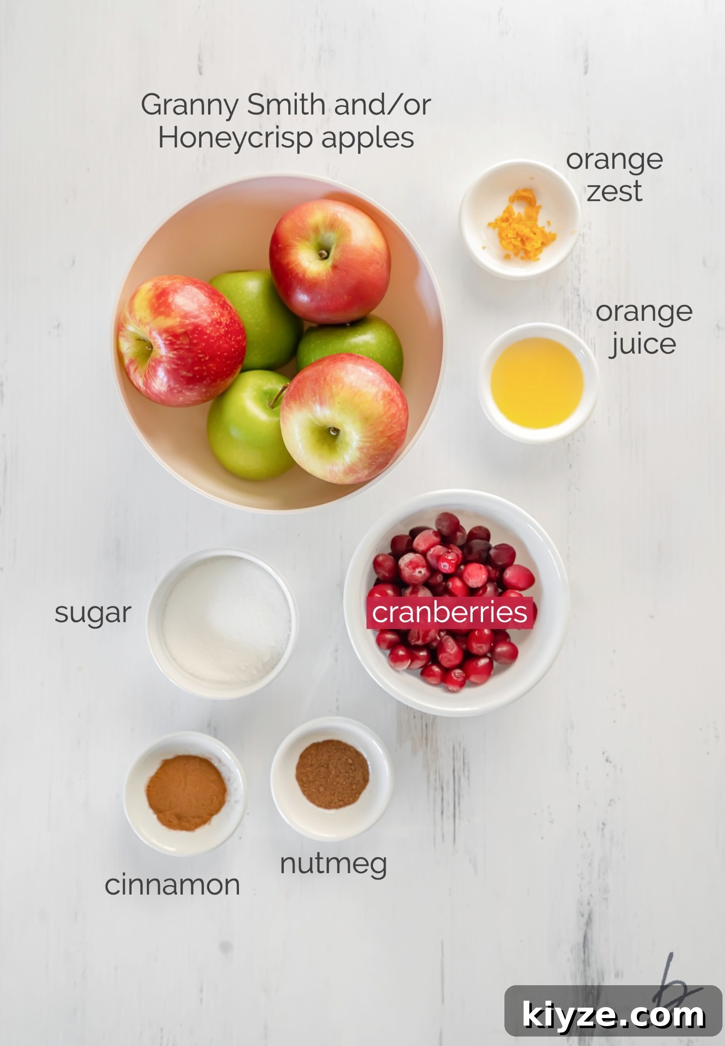 Apple Cranberry Crisp Recipe with Cinnamon Streusel 3 apple cranberry crisp filling ingredients in bowls labeled with text.