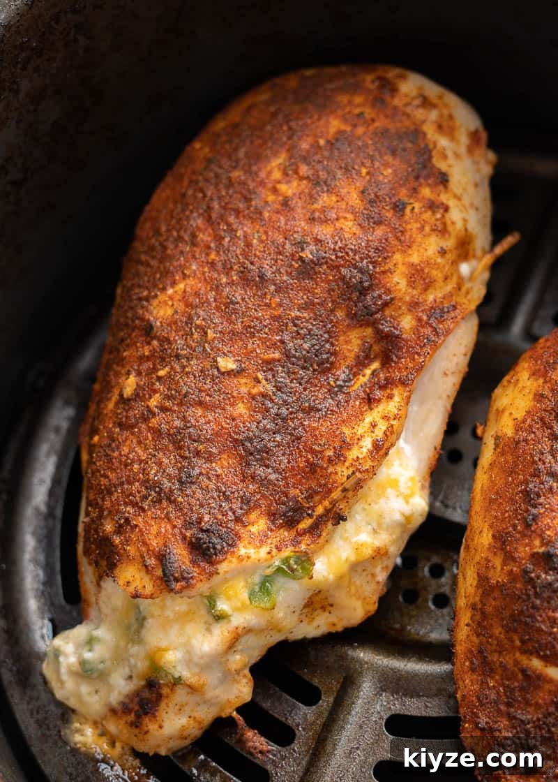 This easy Air Fryer Stuffed Chicken Breast recipe is perfect for a busy weeknight! Naturally gluten free, low carb, and bursting with cheesy, spicy flavor!