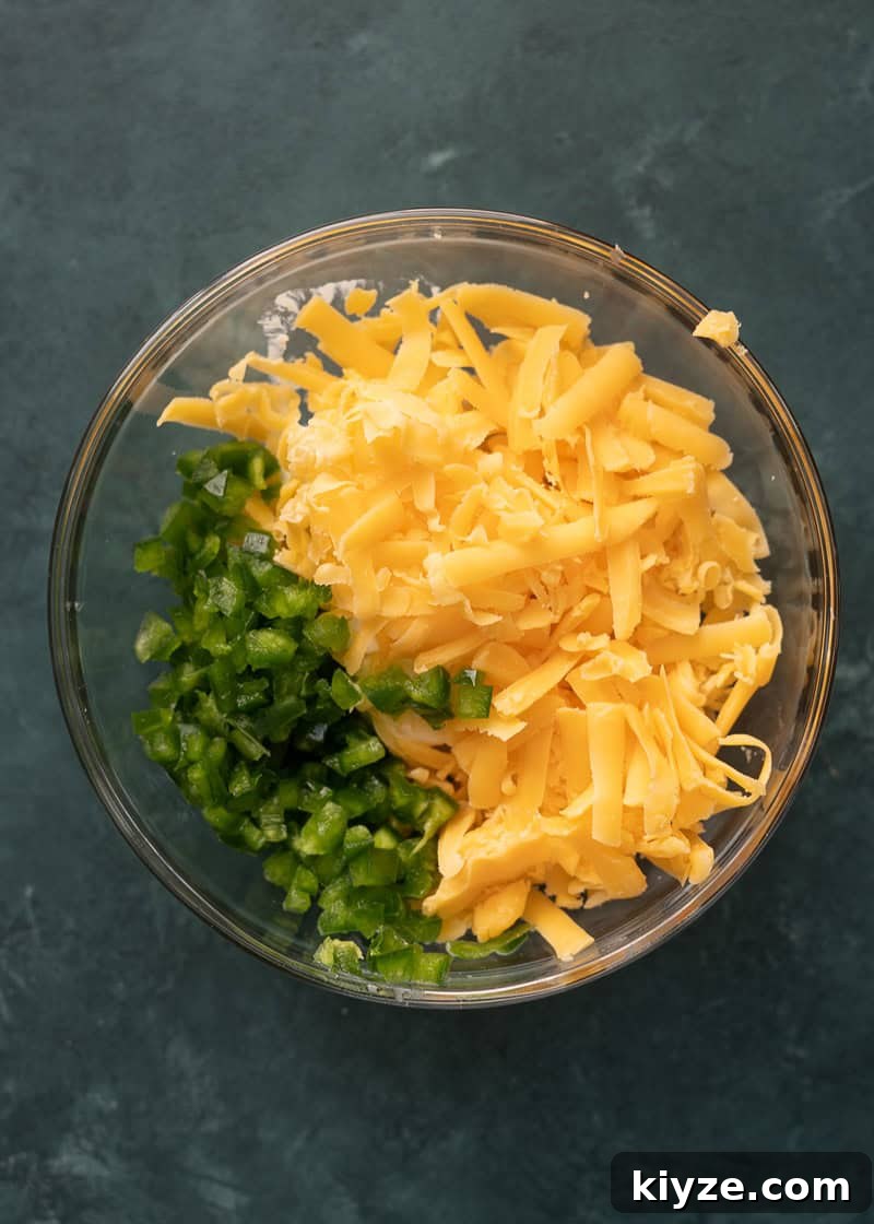 cream cheese, shredded cheese, jalapeno, and seasonings in a glass bowl