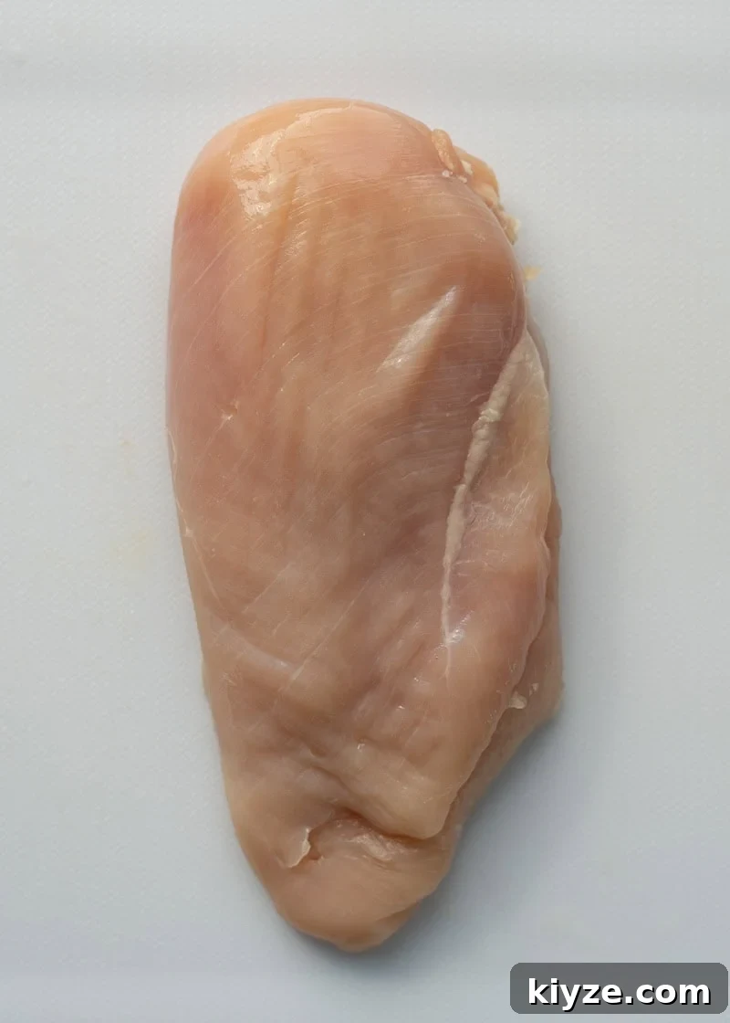 a chicken breast on a cutting board