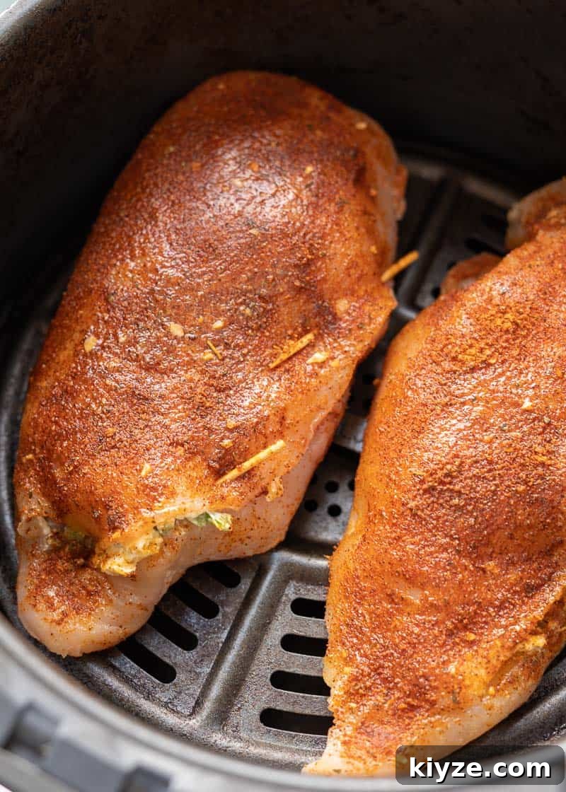 This easy Air Fryer Stuffed Chicken Breast recipe is perfect for a busy weeknight! Naturally gluten free, low carb, and bursting with cheesy, spicy flavor!