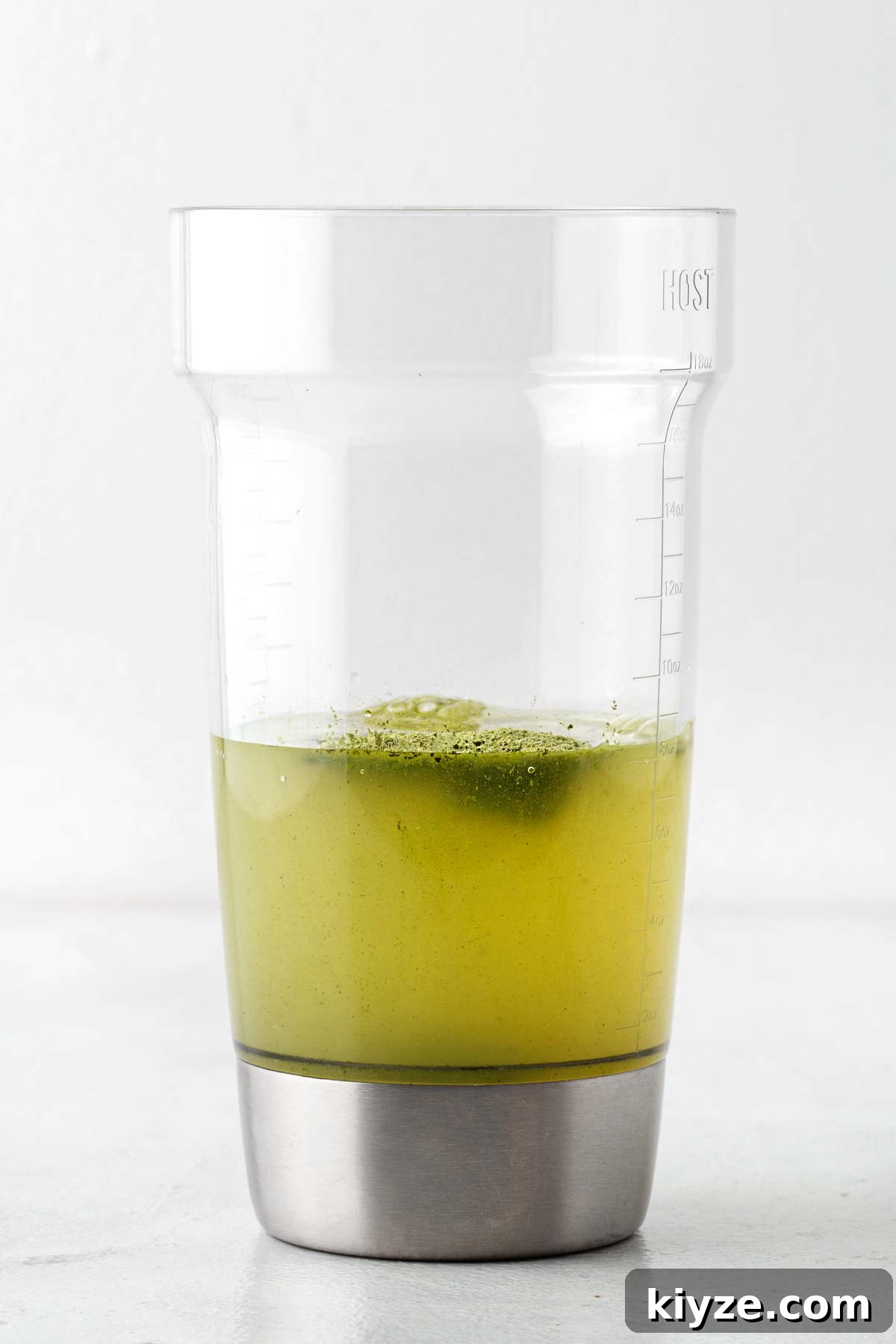 Iced Pineapple Matcha Latte Recipe: Refreshing Tropical Drink 6 Cocktail shaker containing lemonade and matcha powder.